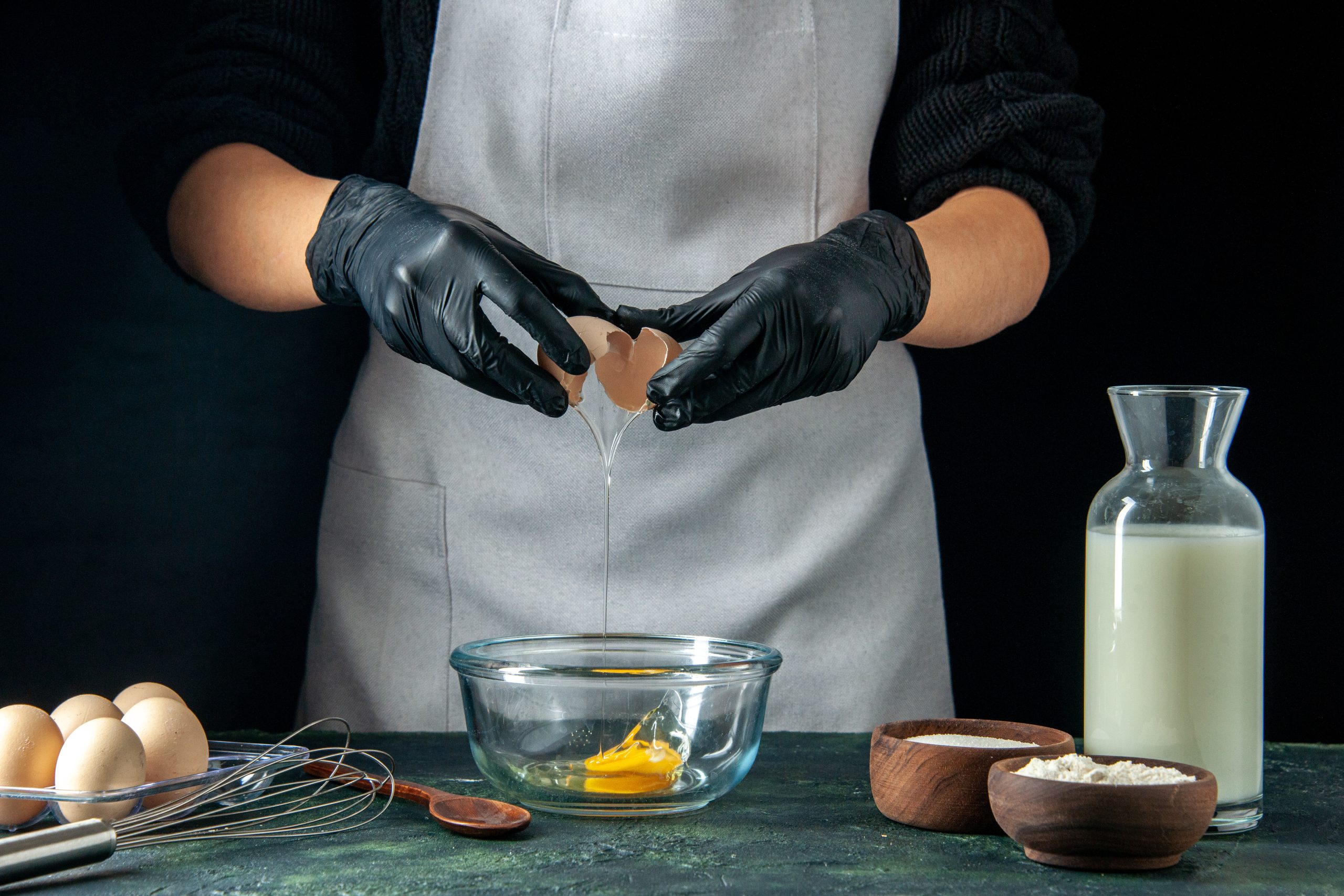 Poza curs patiser front-view-female-cook-breaking-eggs-dough-dark-pastry-job-cake-pie-bakery-worker-cuisine_Info_Center_Group Curs PATISER - imagine 1
